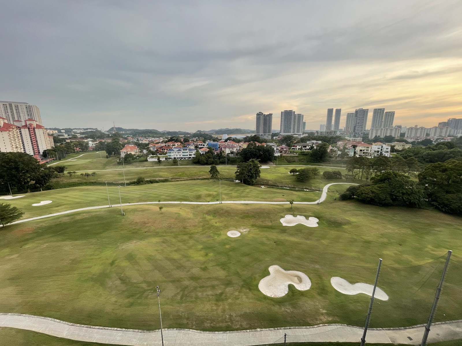 Savanna: A wide view of a golf course and distant city skyline
