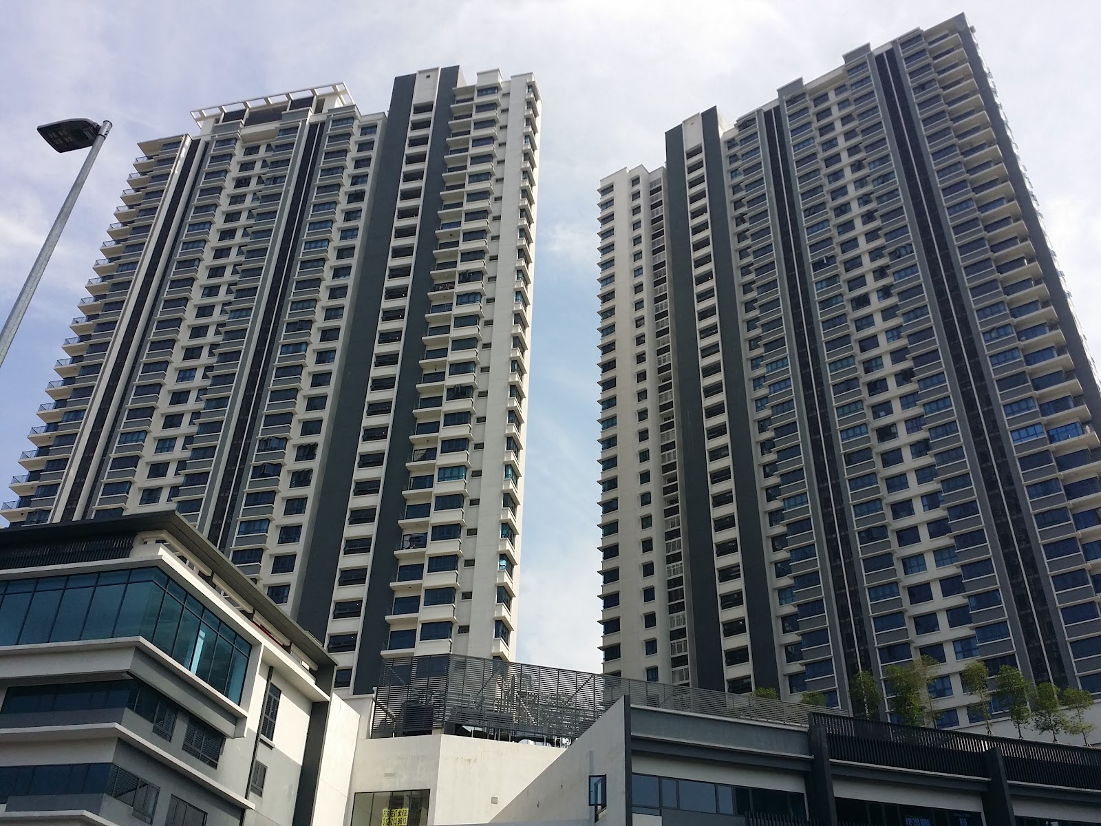 The Link 2: The facades of two tall residential towers with light and dark vertical stripes, viewed from a low angle.
