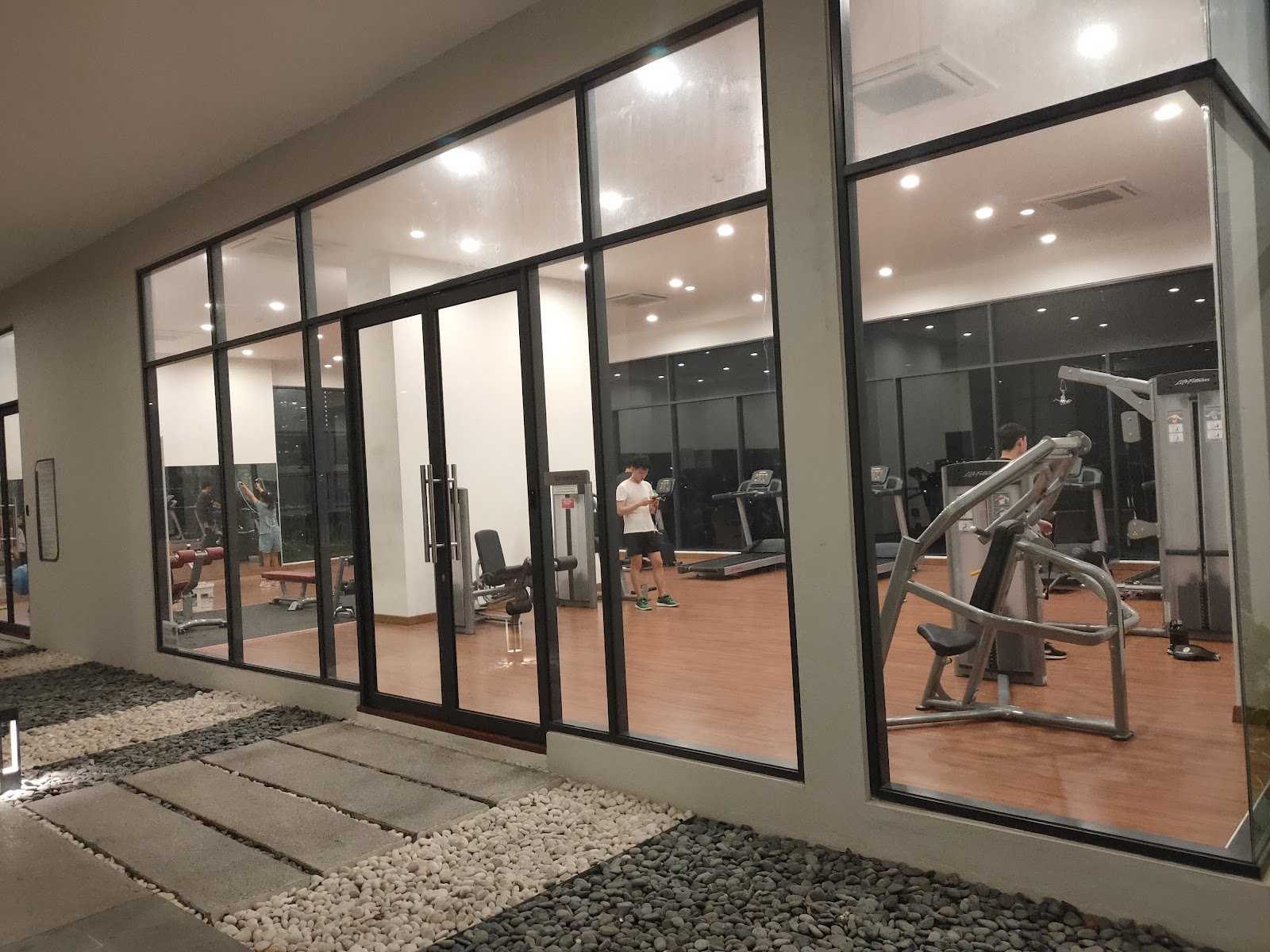 The Link 2: A modern gym and fitness center viewed through a large glass facade.