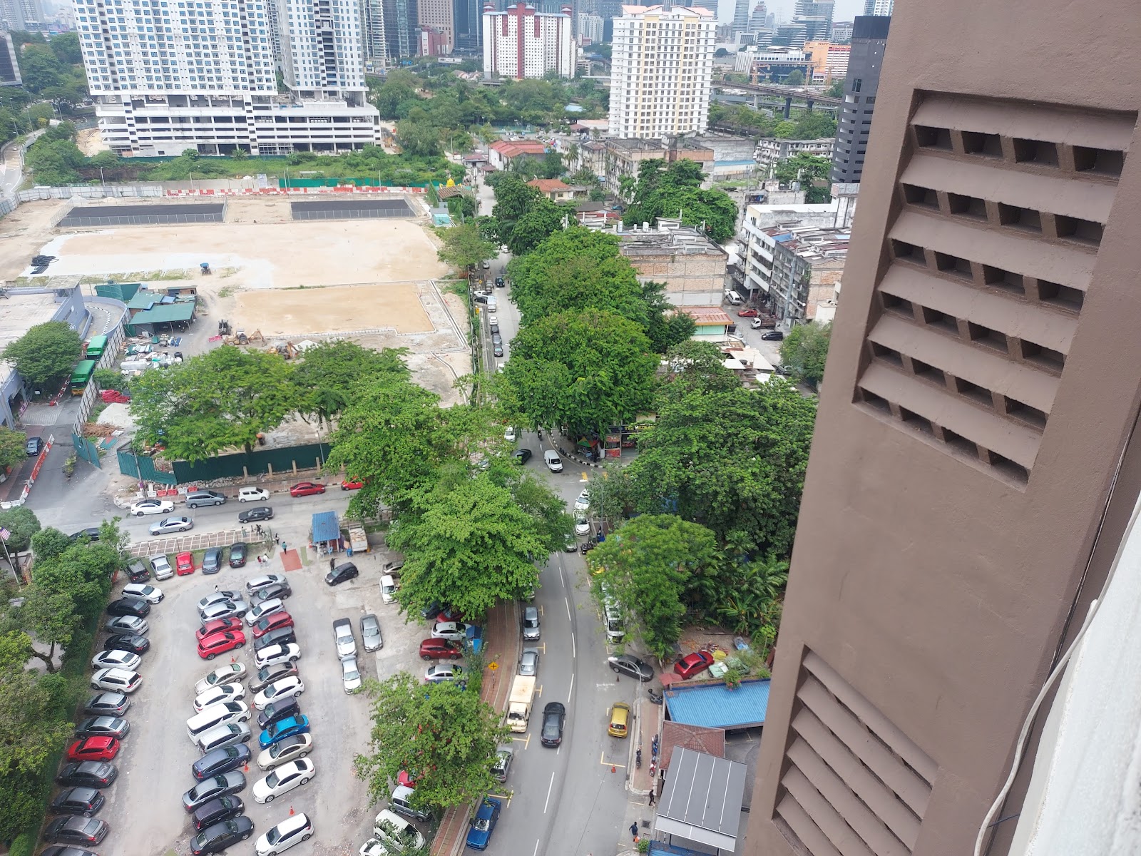 Crescent Court: A view from a high vantage point overlooking a city street, a parking lot, and surrounding buildings.