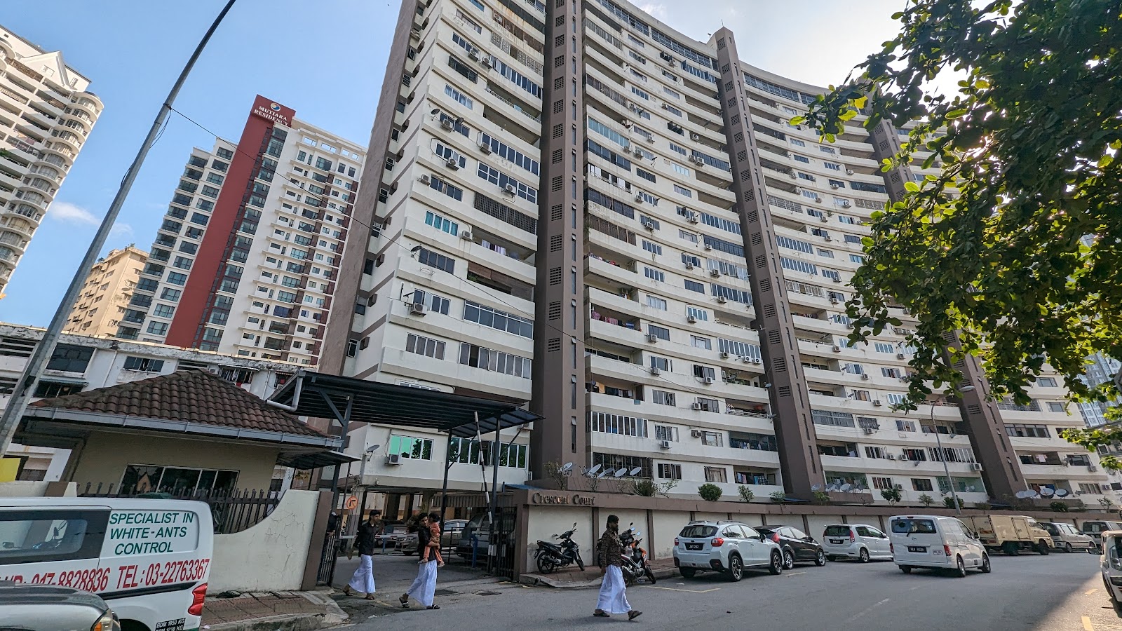 Crescent Court: The exterior facade of a multi-story residential apartment complex, with the name 'Crescent Court' visible on the ground level wall.