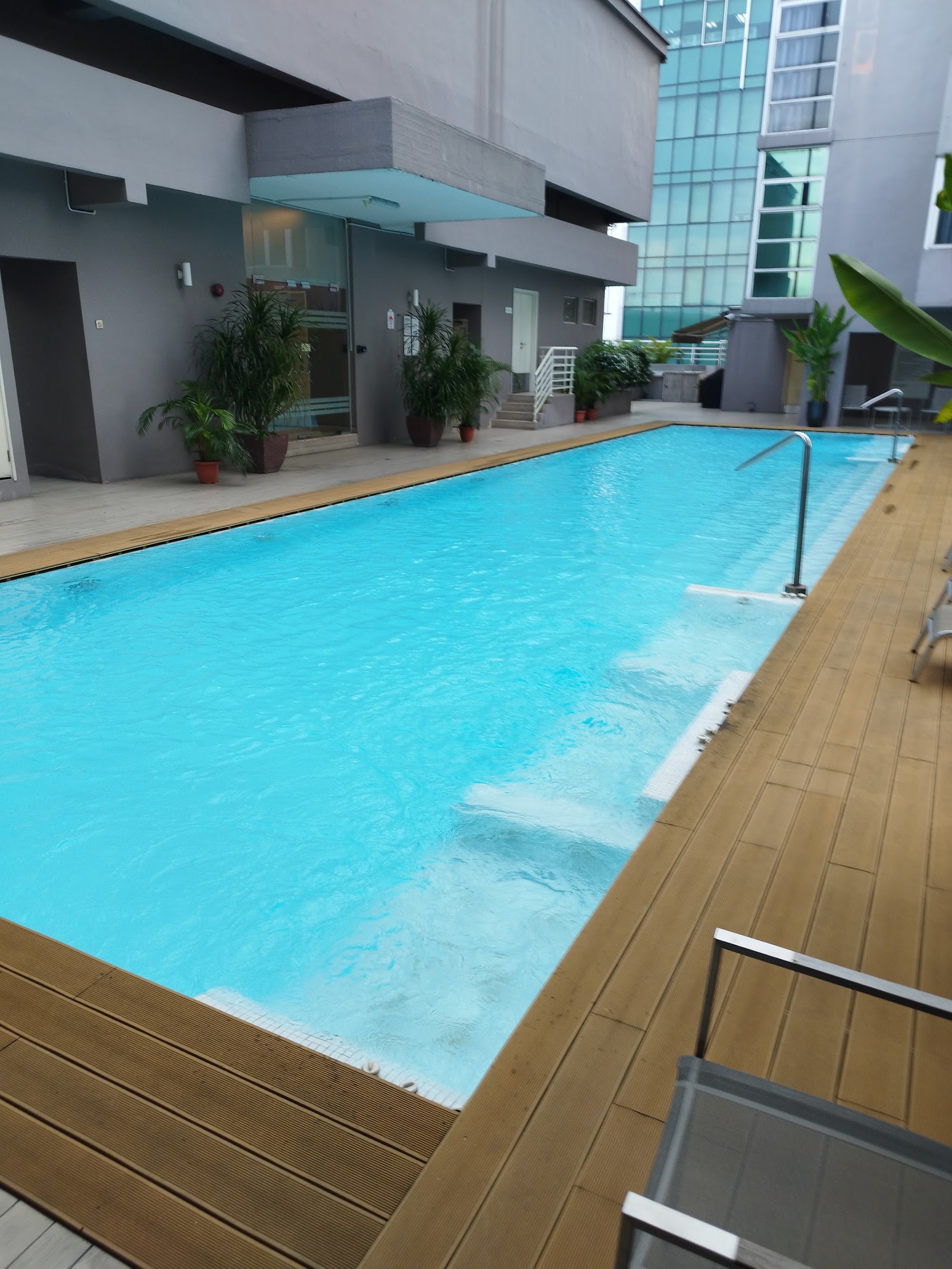 Bintang Goldhill: Swimming pool with tiled deck and potted plants.