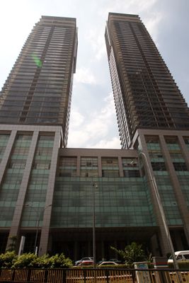 Pavilion Residences: Low-angle exterior shot of the two towers and podium of Pavilion Residences.