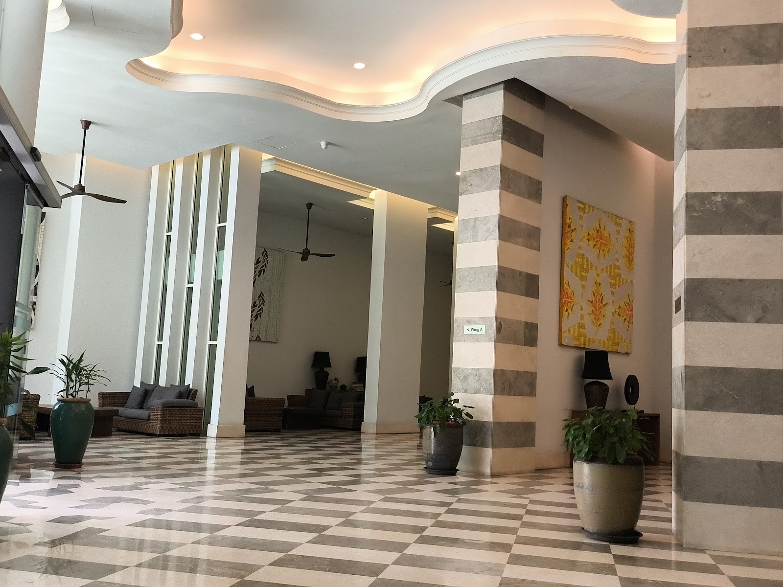 Armanee Terrace: A spacious hotel lobby or reception area with a checkered marble floor, patterned pillars, and comfortable seating.