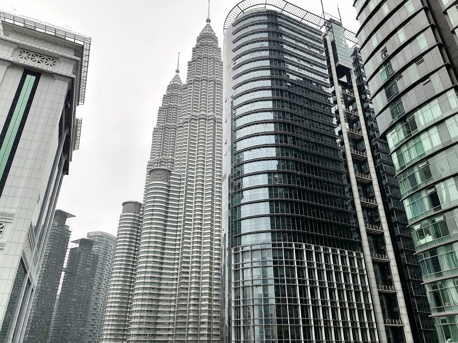 Idaman Residence: A view of the Kuala Lumpur skyline featuring the Petronas Twin Towers and adjacent modern buildings.
