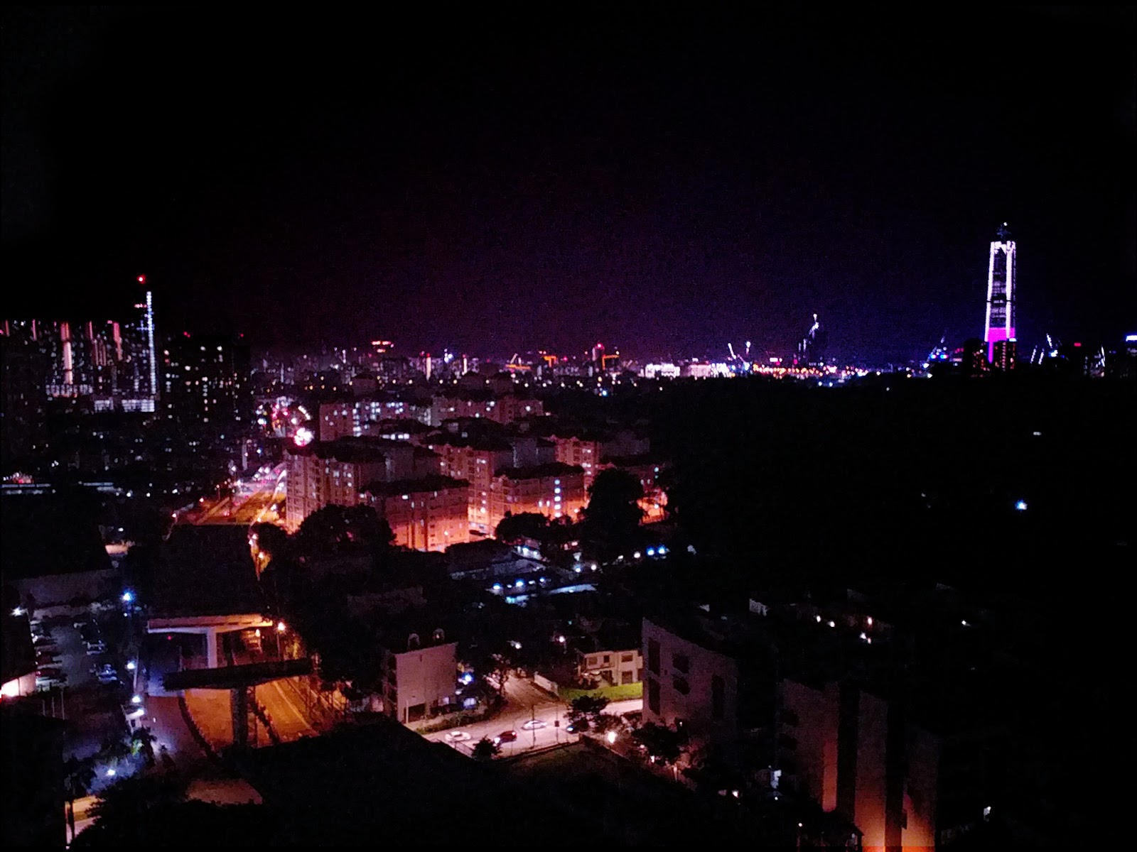 Tara Condominium: A panoramic night view of a city skyline from an elevated position, with a dark foreground.
