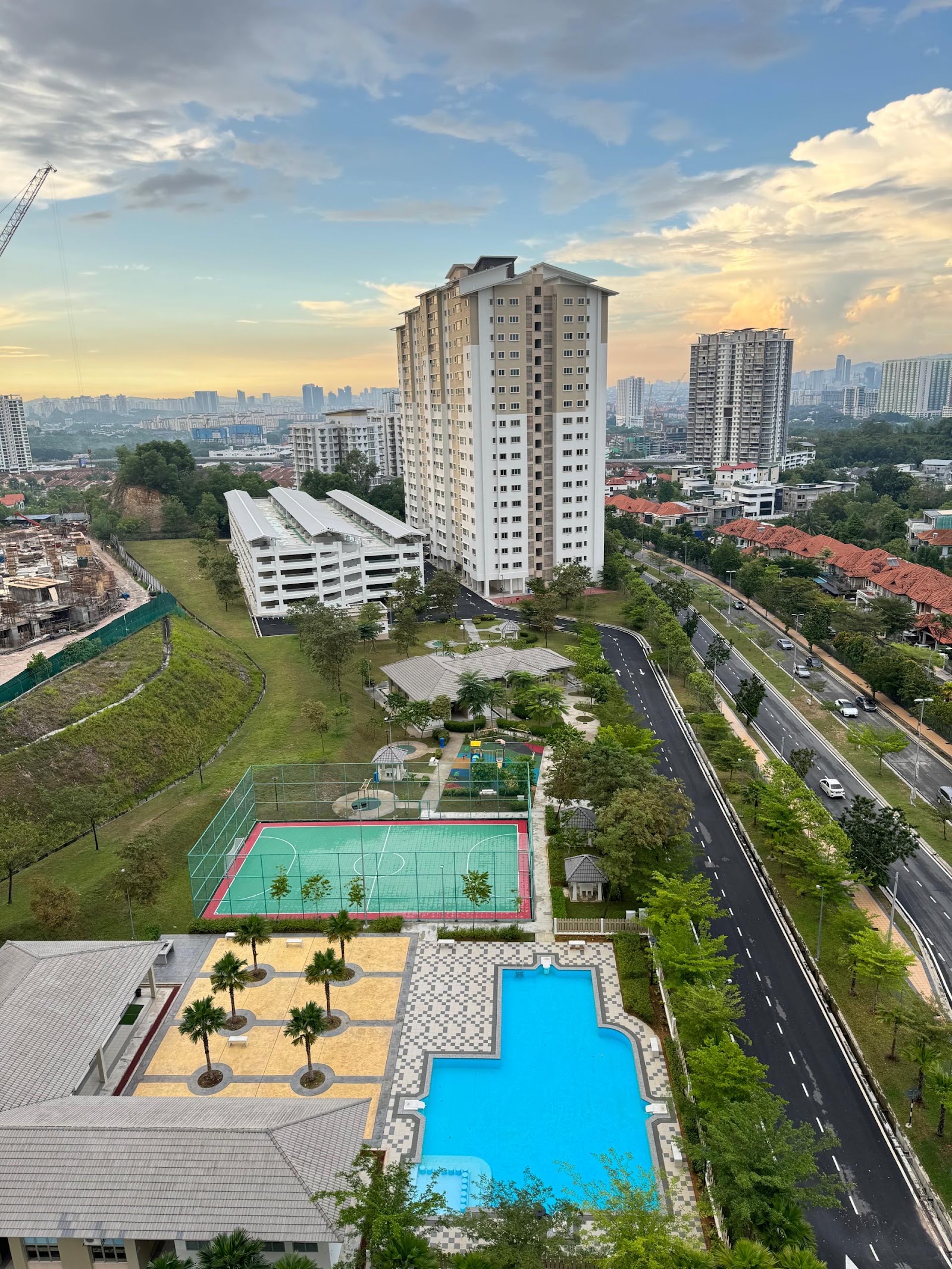 Condominium Akasia Bukit Jalil: A pool, basketball court, and playground are laid out below, with the high-rise tower standing in the background.