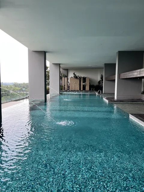 Senza Residence @ DK City Bandar Sunway: A high-level outdoor swimming pool with a covered ceiling, water features, and a view of the distance.