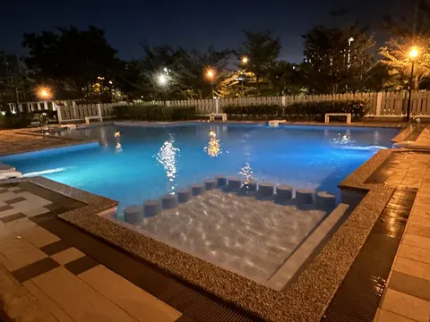 Condominium Akasia Bukit Jalil: An outdoor swimming pool illuminated at night, featuring a shallow entry section with steps and underwater lighting.