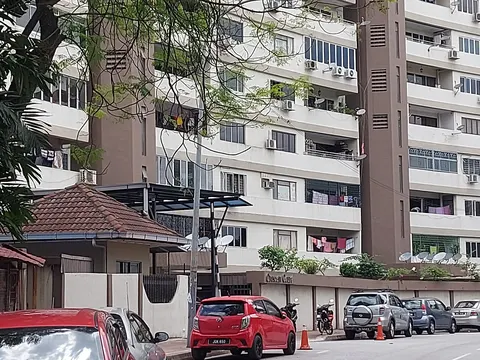 Crescent Court: Exterior view of the Crescent Court apartment building facade with parked cars on the street in the foreground.