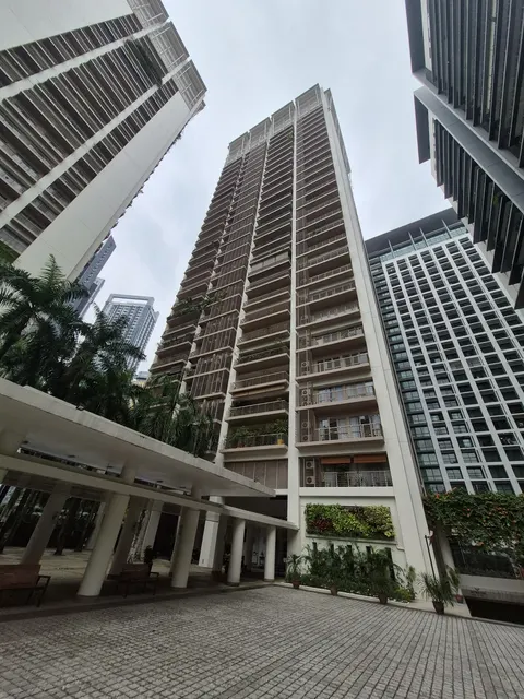 Hampshire Park: A low-angle view looking up at a cluster of high-rise residential towers, including a central tower with prominent balconies and vertical fins, flanked by two other buildings.