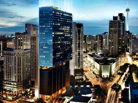 Dorsett Residences Bukit Bintang: A twilight view of the Dorsett Residences Bukit Bintang tower, a modern high-rise building with blue glass windows, standing among other skyscrapers and city lights in Kuala Lumpur.