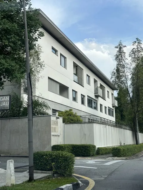 Iringan Hijau: A photograph of the 'Iringan Hijau' building, showing its white facade and ground-level signage from a street-level perspective.