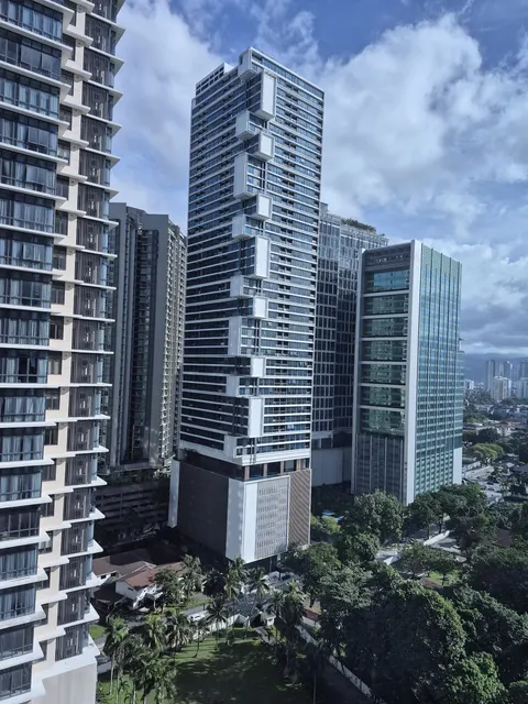Eaton Residences: A daytime view of the Eaton Residences skyscraper and its surrounding buildings and landscape.