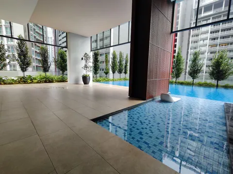ARIA Luxury Residence: An outdoor swimming pool area with blue tiles and a tiled deck surrounded by manicured trees and landscaping.