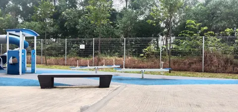 PPA1M Bukit Jalil: An outdoor playground area featuring a blue play structure, spring riders, and a bench.