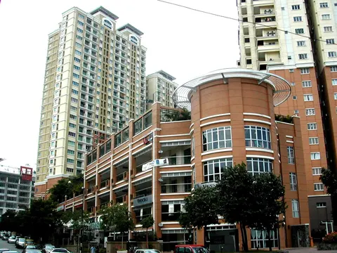 Emerald Serviced Apartment: Exterior view of the Emerald Serviced Apartment complex featuring a cylindrical orange podium block and tall residential towers in the background.