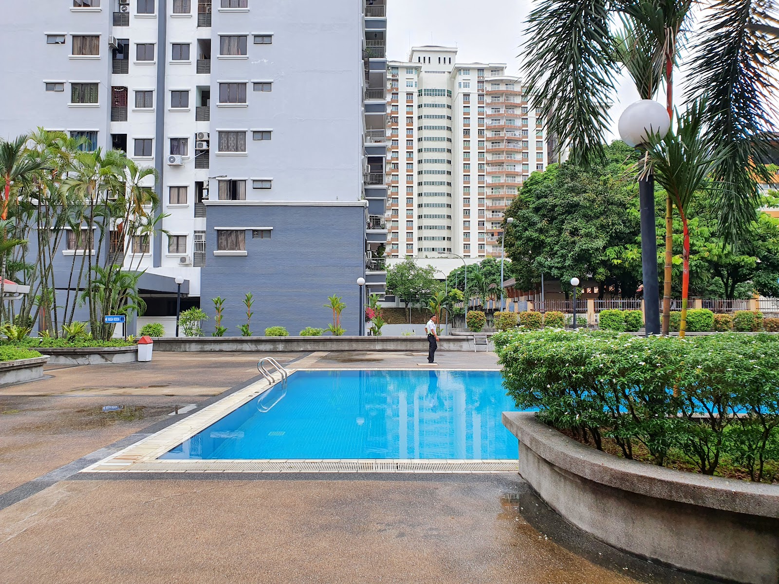 Menara Duta 1: A wide shot of a swimming pool and landscaped garden area within the development, with high-rise residential buildings in the background.