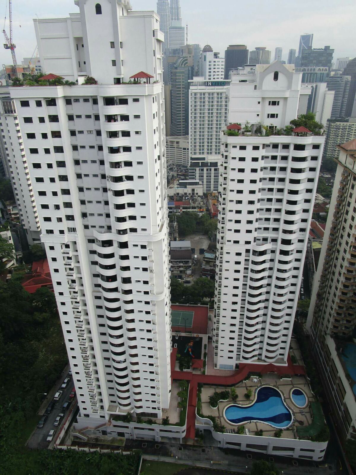 Angkasa Impian 2: An aerial view of a white residential development with two high-rise towers and a podium featuring a swimming pool, tennis court, and other amenities.