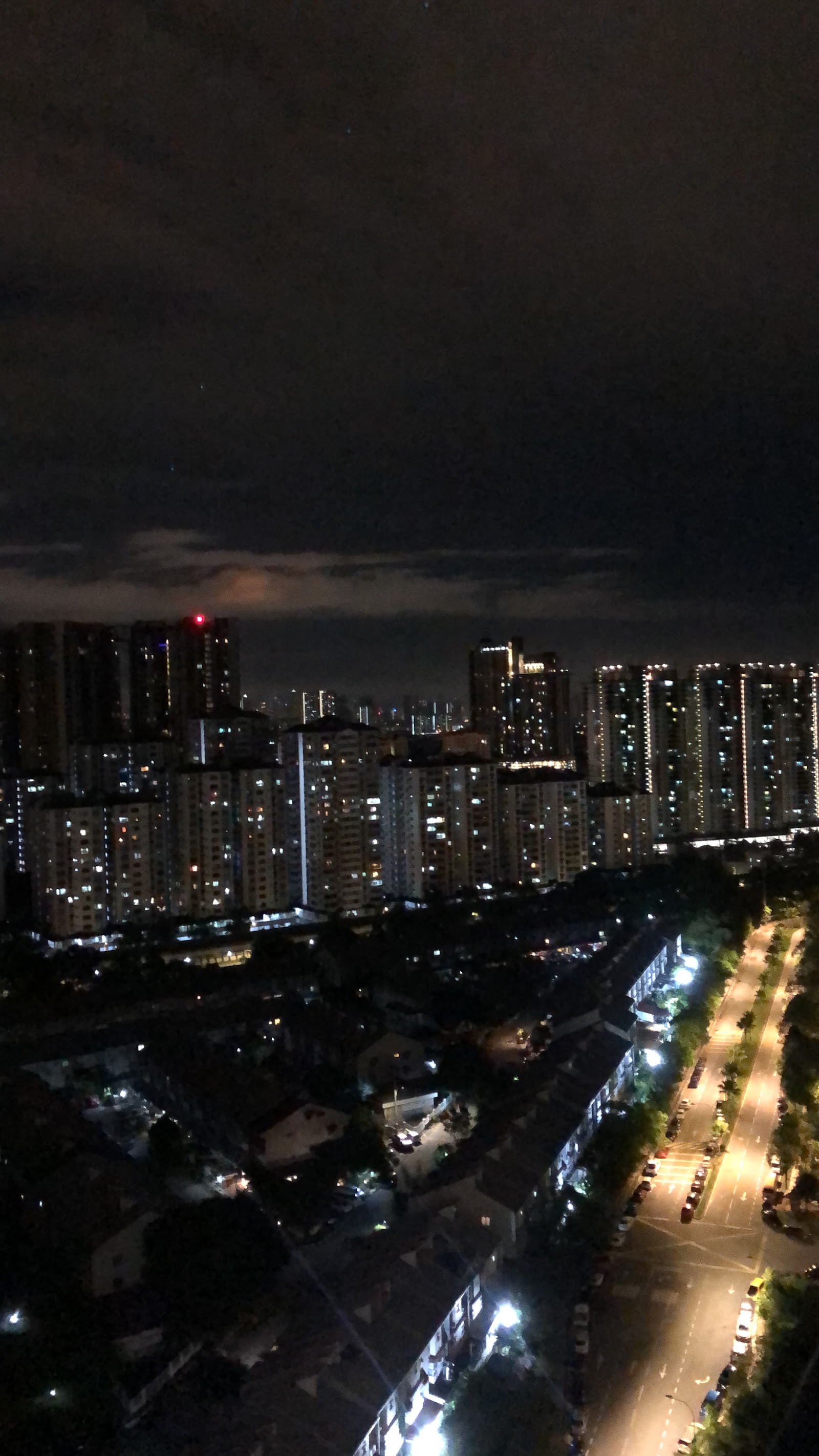 Residensi Jalilmas @ Bukit Jalil: A high-angle night view of a city skyline with illuminated high-rise residential towers and a lit street below, seen from an elevated position.